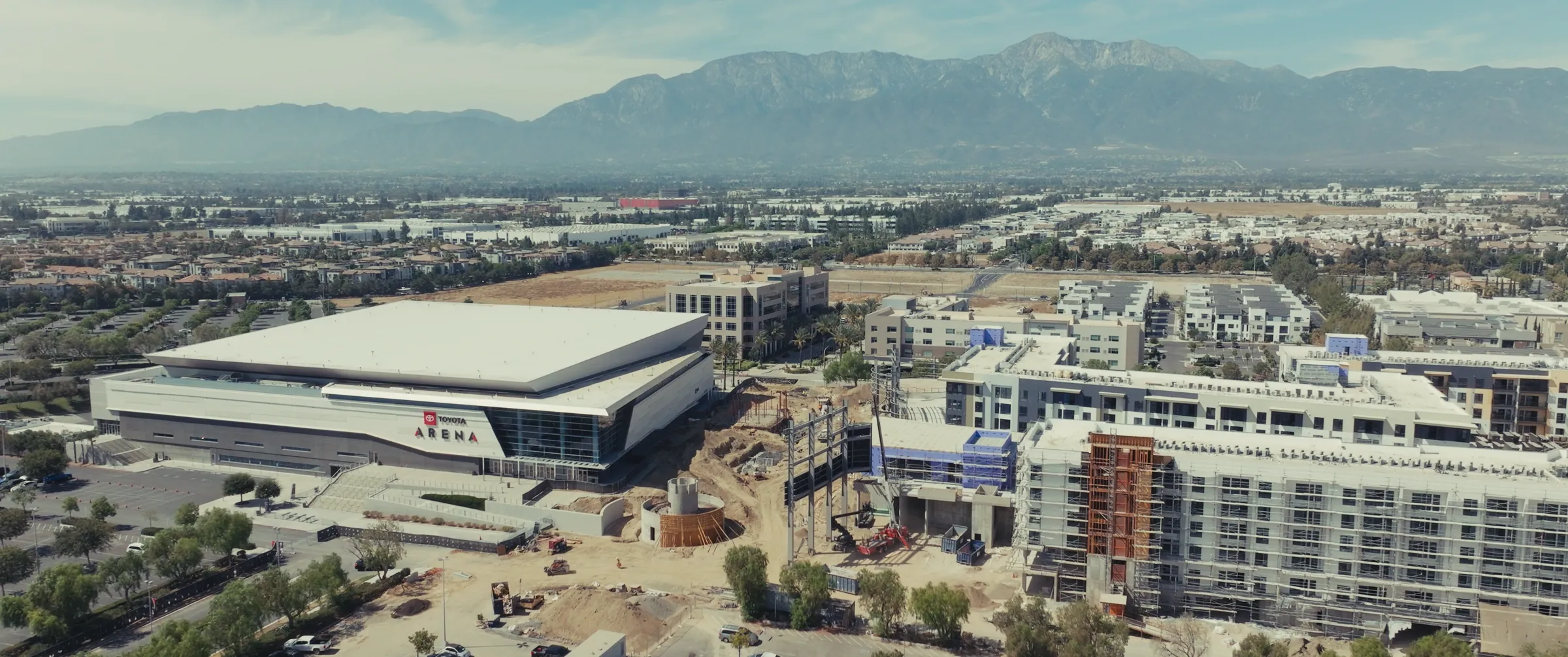 Toyota Arena and Phase One under construction, with the San Gabriel Mountains behind