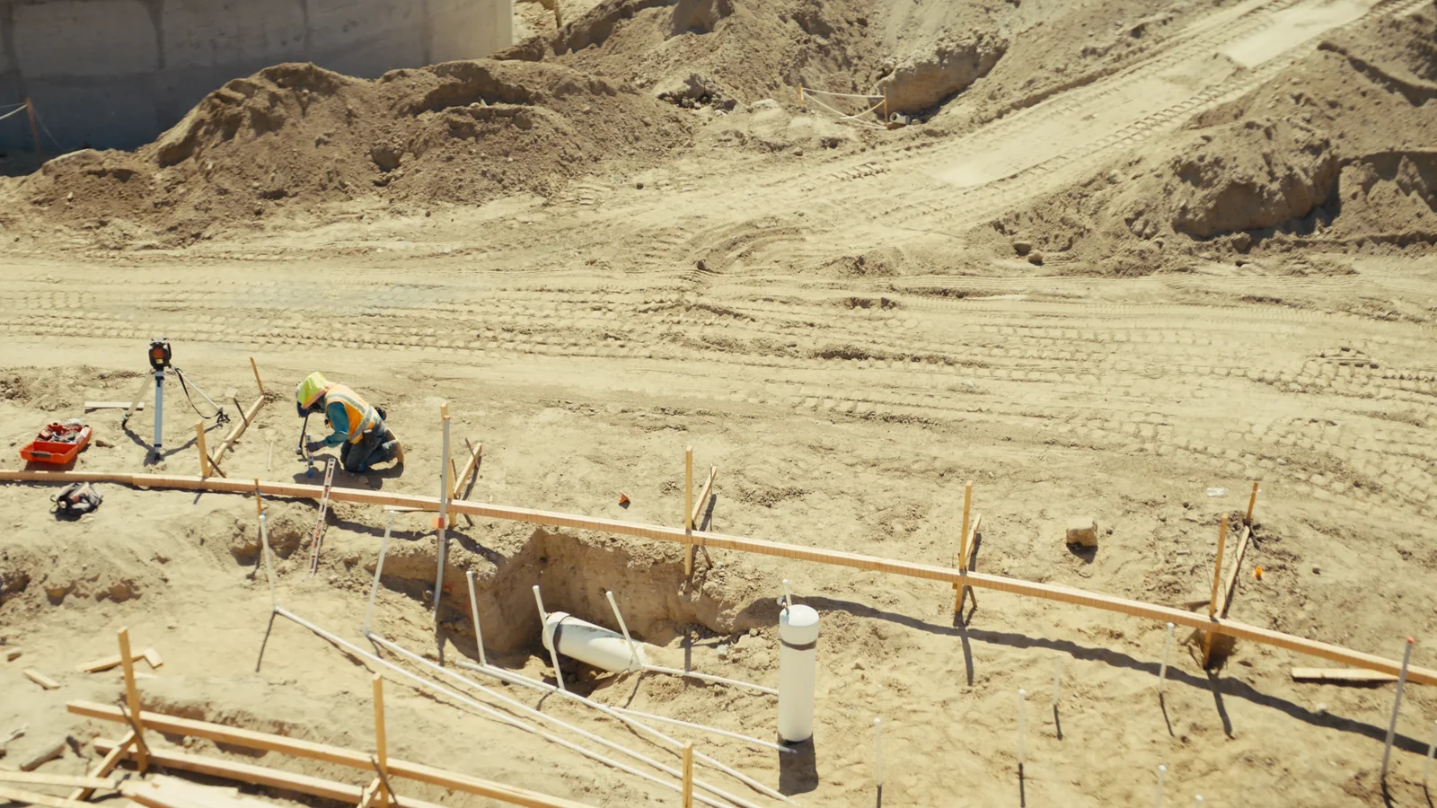 Groundwork and survey stakes in the dirt on site