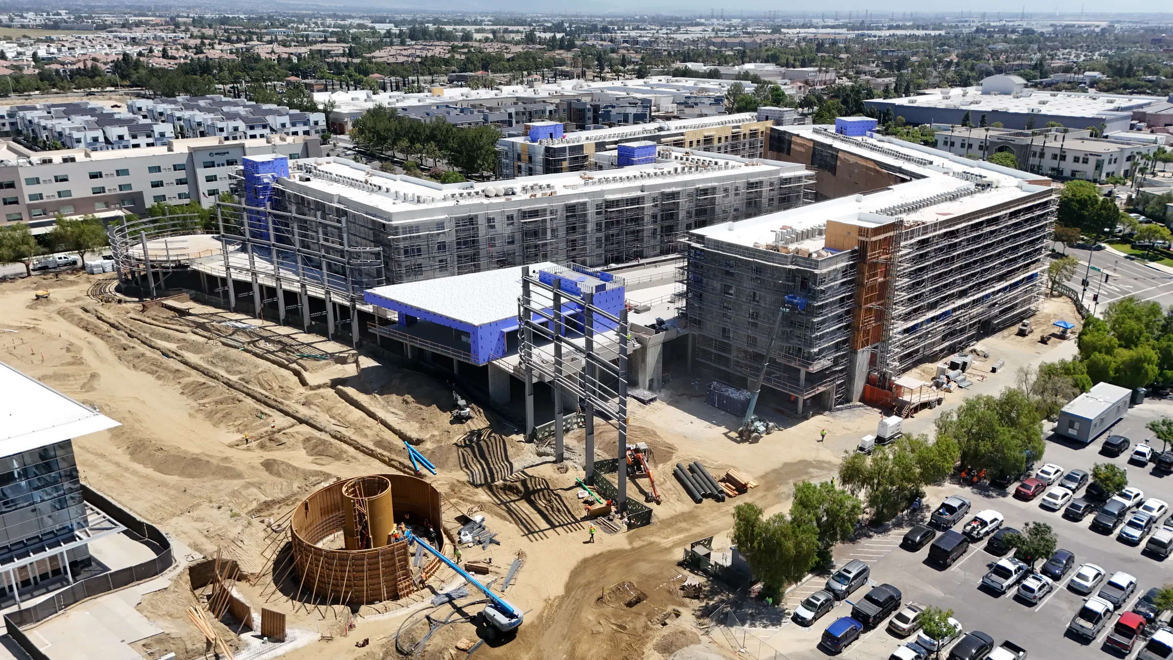 Drone photograph, June 2026: Phase One rising beside Toyota Arena, the Plaza fountain formwork in the foreground
